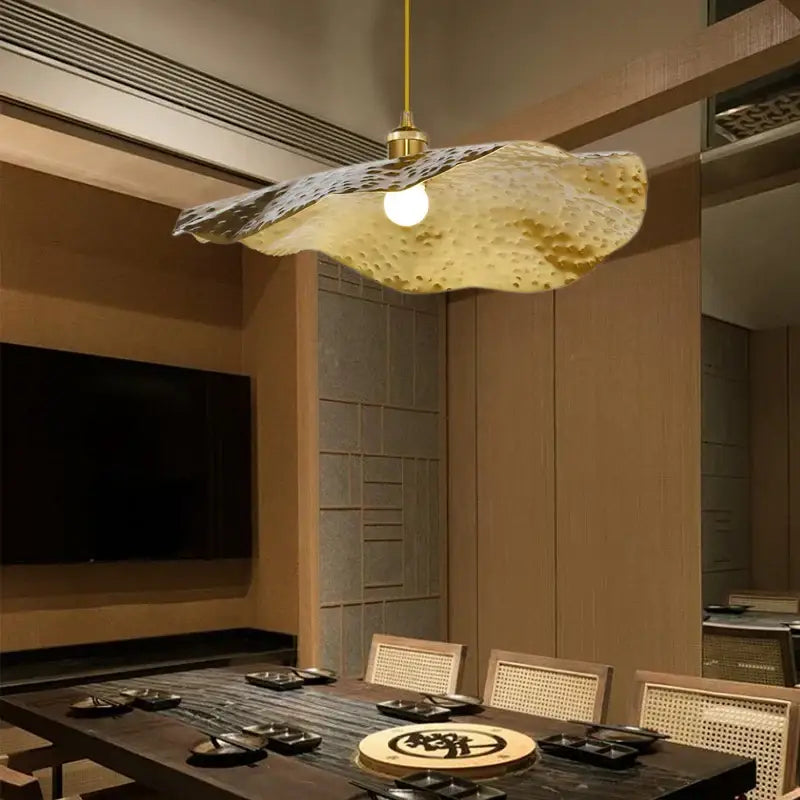 Gold lotus leaf pendant light with hammered metal finish in golden yellow for living room decor by decorbites gold lotus