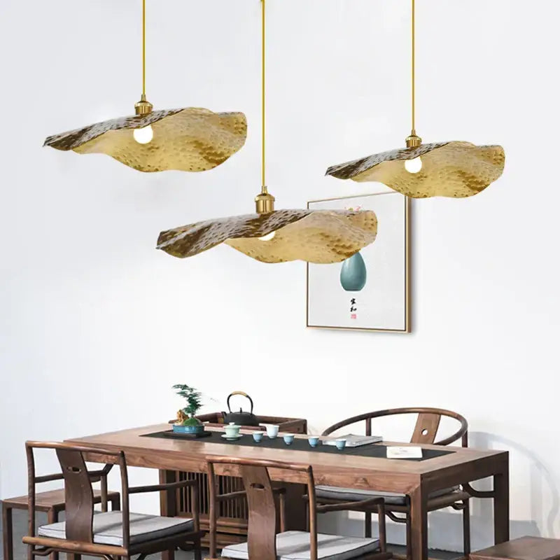 Three gold lotus leaf pendant lights with hammered texture from decorbites for living room decor