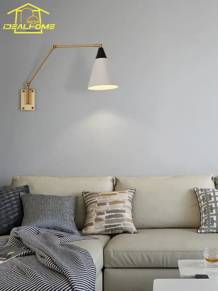 Gold lustre brass swing arm wall lamp with adjustable gold-toned arm and white conical shade by decorbites