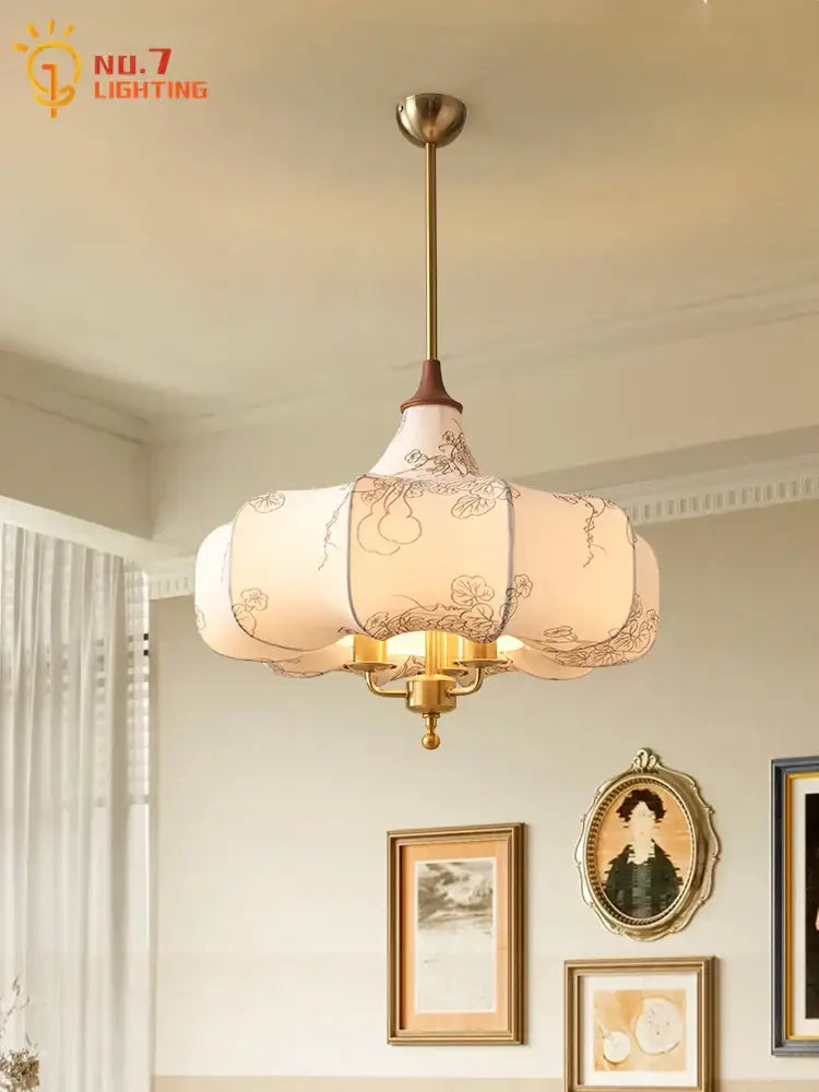 Off-white lantern-style pendant lights with black floral embroidery and brass frame gold lustre medieval decorbites design