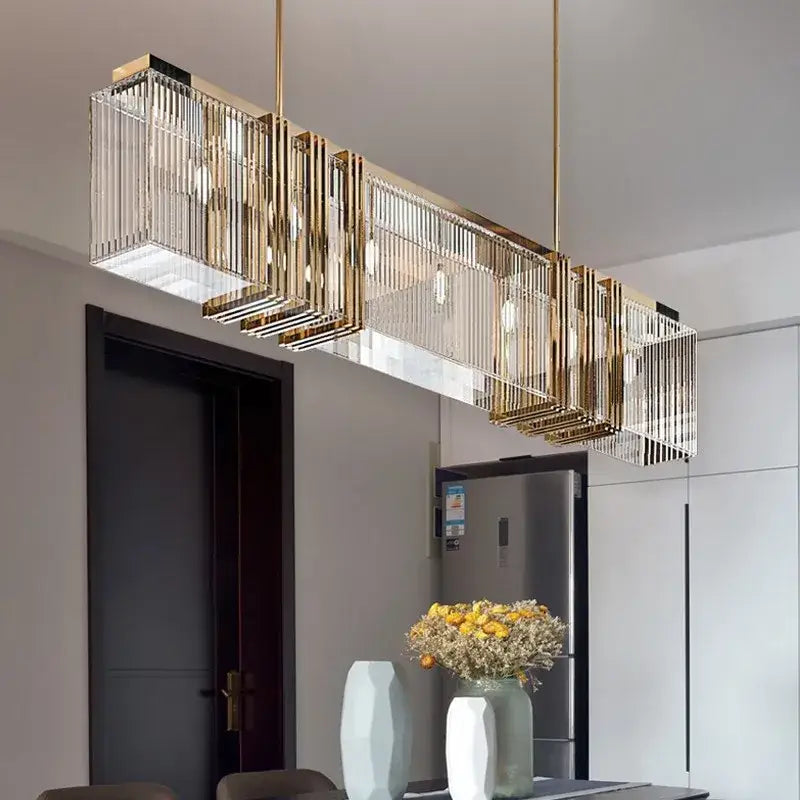 Gold lustre steel pendant light with rectangular gold-toned frame, vertical glass rods, and exposed bulbs for dining room decorbites gold lustre