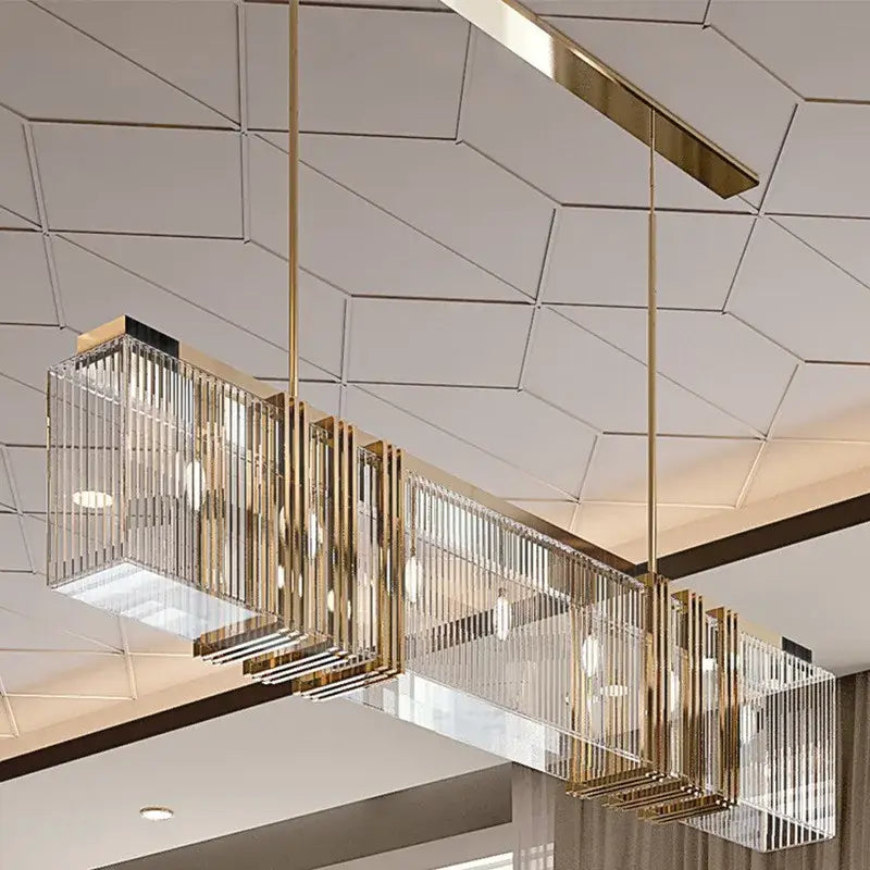 A gold lustre steel decorbites pendant light with a rectangular metal frame and vertical crystal rods for dining room decor