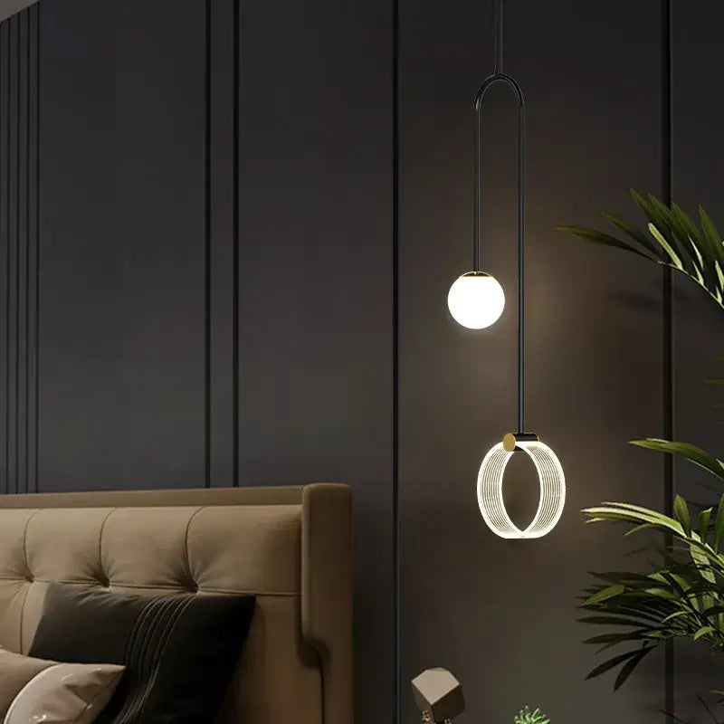 Modern black pendant light with spherical bulb and illuminated ring in decorbites gold luxury led pendant light design