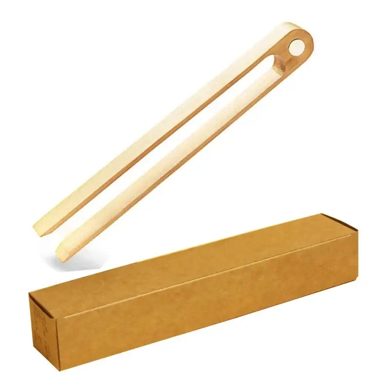 Light-colored bamboo toaster tongs with a smooth natural finish and rounded ends for kitchen bread tools