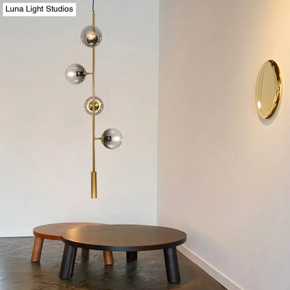 Lámpara de techo colgante estilo globo modernista dorado con cristal gris y 4 bombillas para salón.