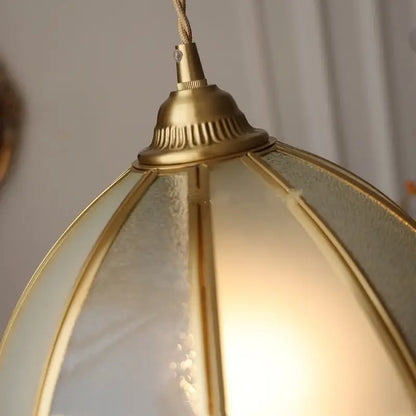 Gold-toned brass glass led pendant lamp with frosted glass panels and warm textured glow for kitchen lighting