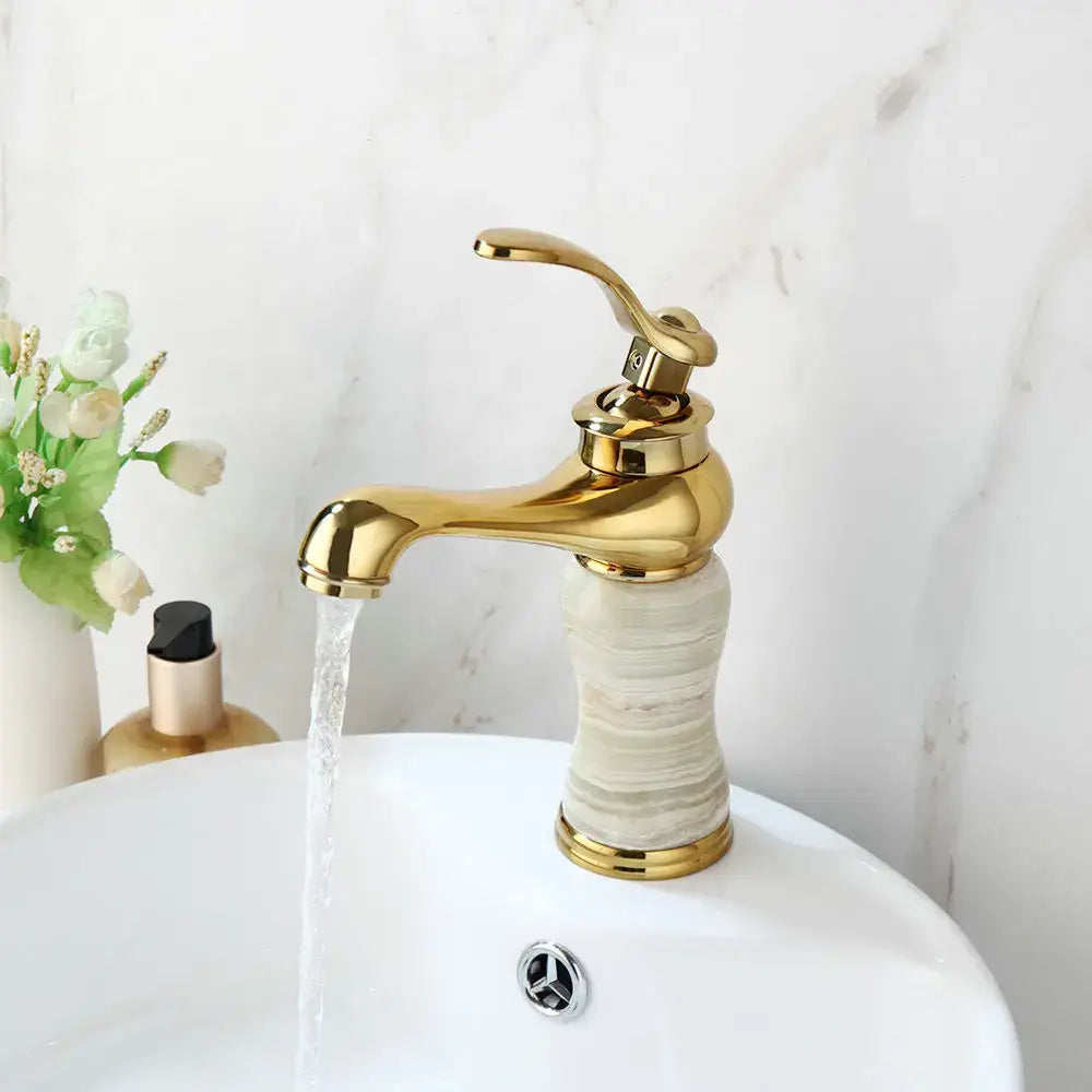 Gold plated jade bathroom faucet with elegant curved spout and handle, marble textured base hot cold mixer