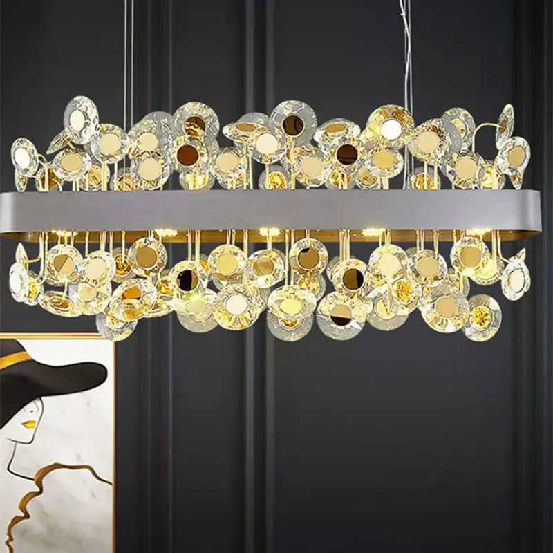Gold rectangular crystal pendant chandelier with sleek metallic frame and warm glowing decorbites crystal discs for dining room decor