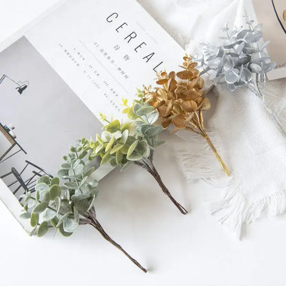 Artificial eucalyptus leaves in gold silver and green metallic finishes on slender stems for decorbites eucalyptus leaves decor