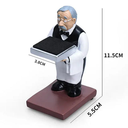 A miniature gray-haired waiter figurine holding a silver tray on a bear statue watch rack for bedroom storage
