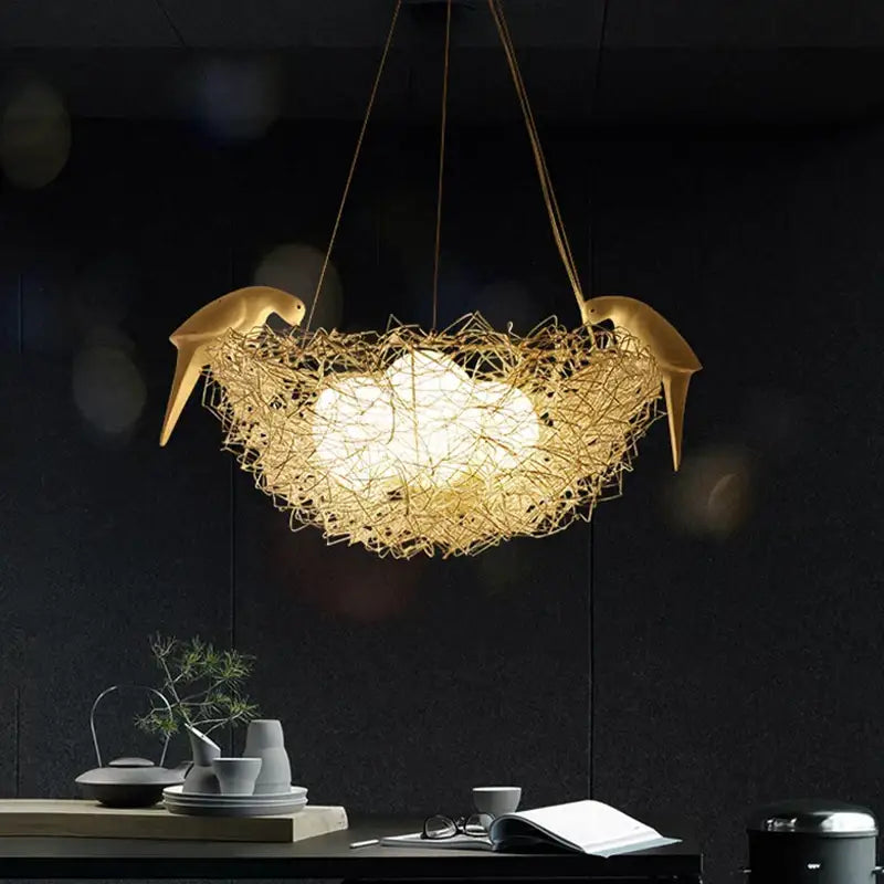 Golden bird-shaped pendant light with woven nest design and warm bulb glowing for dining room nest pendant lights