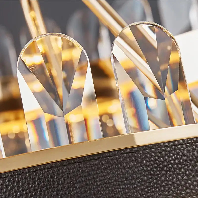 Gold stainless steel crystal chandelier dining room detail with gold-framed faceted crystals on black leather strap