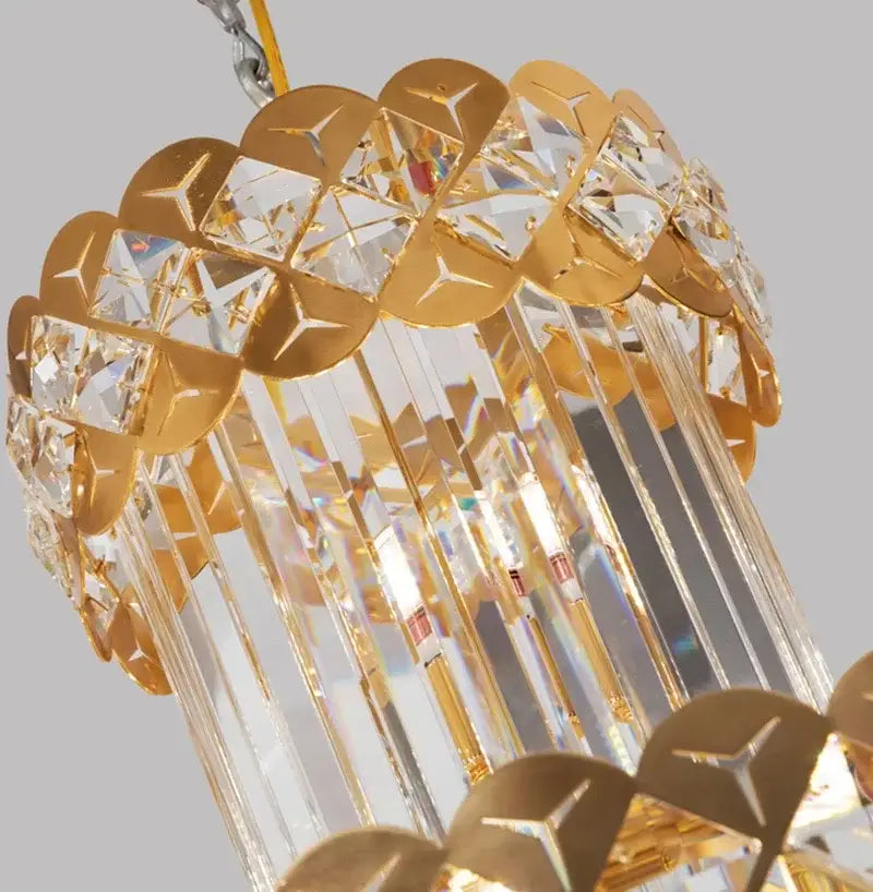 Gold stainless steel pendant light chandelier with clear crystal prisms and metallic scalloped decorbites gold stainless accents