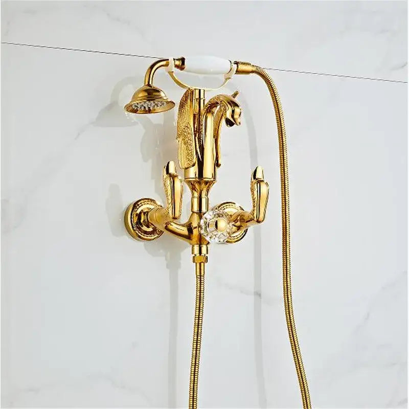 Gold swan bathtub faucet set in gold finished brass with ornate swan spout, crystal knobs, and white ceramic handle by decorbites
