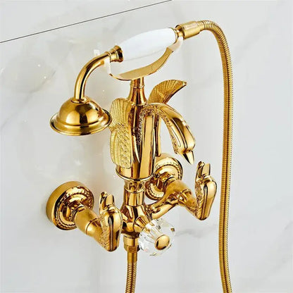 Gold swan bathtub faucet set with ornate swan handles, crystal knob, integrated showerhead, and flexible hose by decorbites