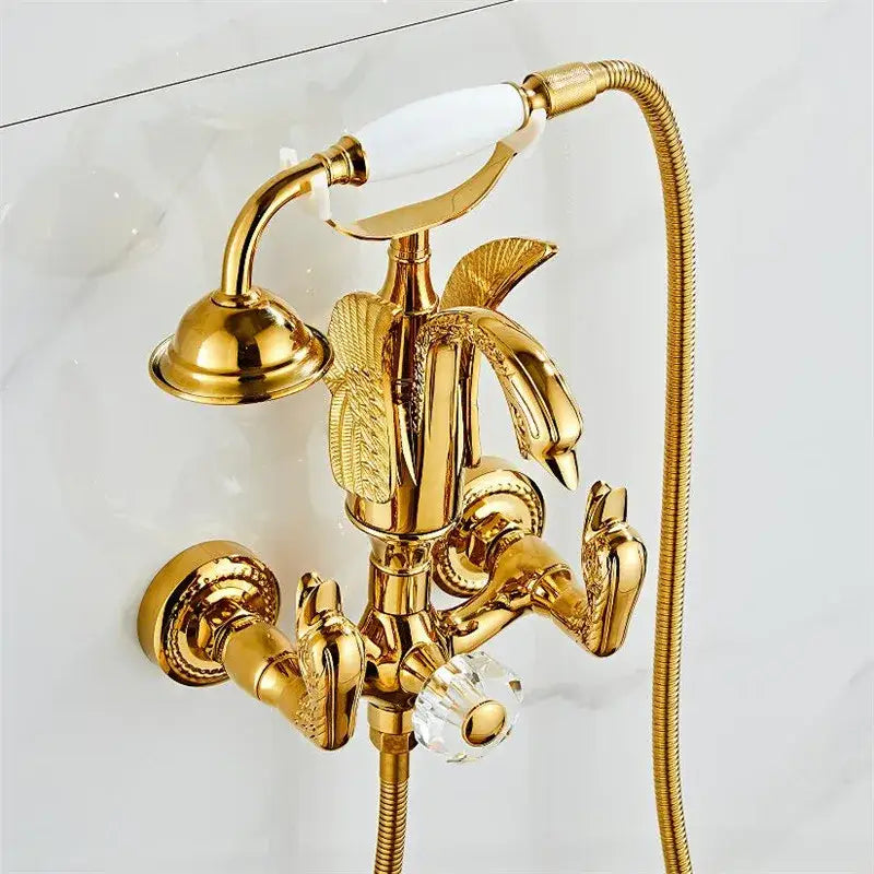 Gold swan bathtub faucet set with ornate swan handles, crystal knob, integrated showerhead, and flexible hose by decorbites