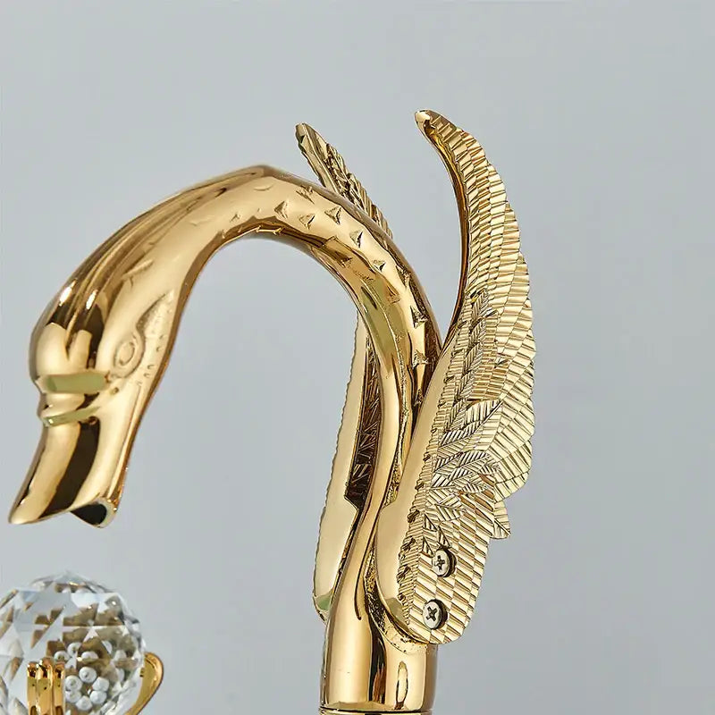Gold swan crystal decorative handle for bathroom faucet with intricate feather detailing and polished metallic finish decorbites gold swan