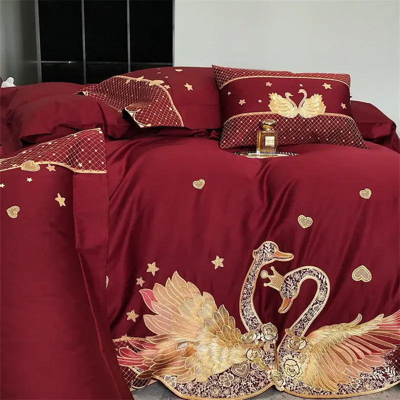 Deep red satin bedding set featuring decorbites gold swan embroidery with stars and hearts for elegant bedroom decorbites gold swan love