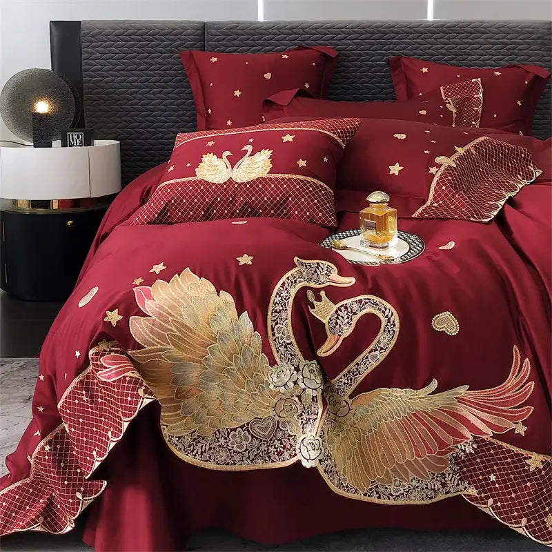 Luxurious burgundy satin bedding set with gold and silver embroidered swans floral details star motifs and netting trim decorbites gold swan