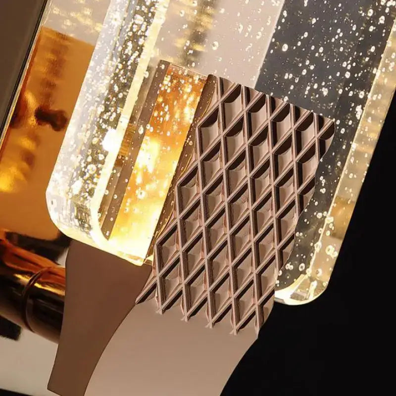 A modern gold textured bubble glass led wall lamp with geometric acrylic panels filled with golden liquid bubbles