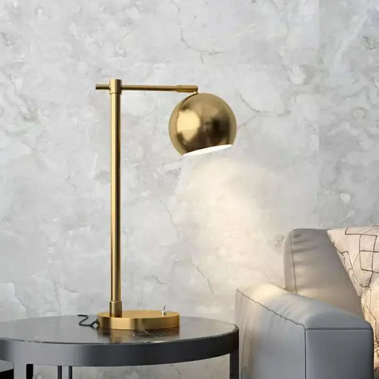 A sleek brushed gold vintage industrial desk lamp with spherical shade and minimalist design for bedroom decorbites gold vintage