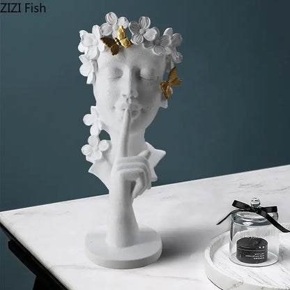 White resin garland figure sculpture of a woman with gold butterflies and white flowers shushing for living room decorbites gold silence