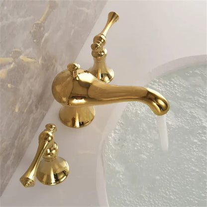 Gold widespread bathroom faucet with waterfall design featuring a gold-finished three-handle widespread bathroom faucet