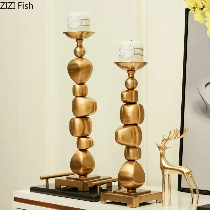 Gold-toned candle holder with stacked rounded geometric segments in polished golden alloy stone by decorbites for living room decor