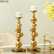 Golden alloy stone pile candle holder with stacked stone design and sleek metallic finish for living room decorbites decor