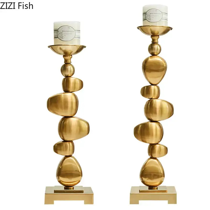 Golden alloy stone pile candle holder with stacked stone-inspired design and sleek metallic finish for living room decorbites golden alloy decor