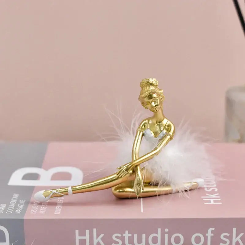Golden and white ballet girl resin figurine featuring a delicate feathered tutu for bedroom desktop décor