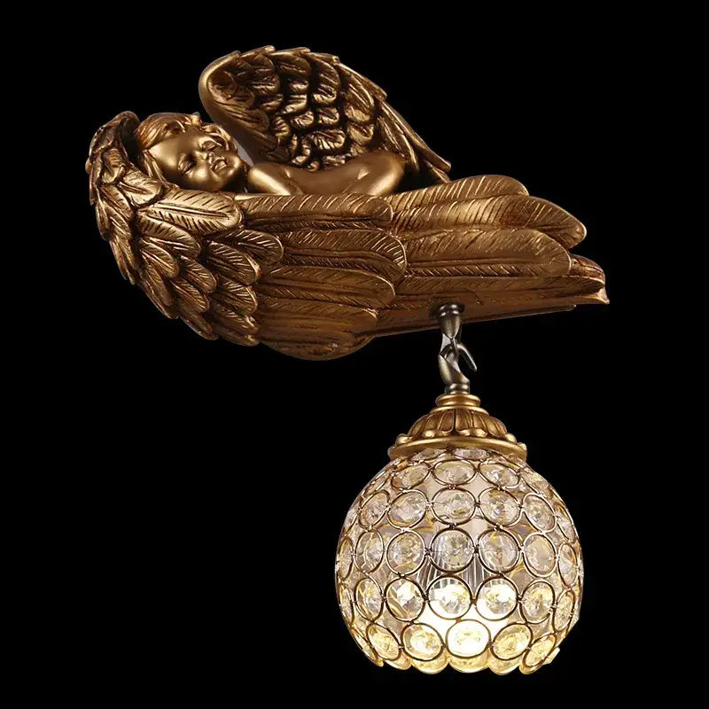 Golden angel wall lamp with crystal globe and detailed wings in gold designed for elegant living room lighting
