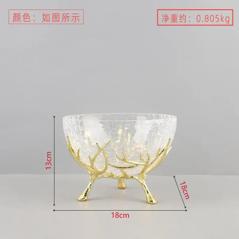 A clear crackled glass fruit plate with a golden antler base ideal as a dining room centerpiece bowl