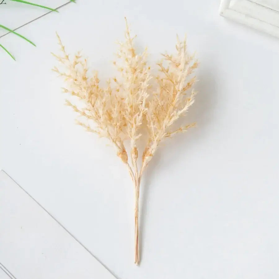 A delicate beige dried grass arrangement with feathery plumes in a golden artificial autumn branches set decorbites decor