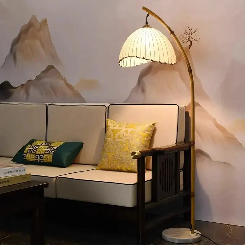 Golden bamboo shaped led floor lamp with marble base featuring a slender gold-toned bamboo style and pleated shade