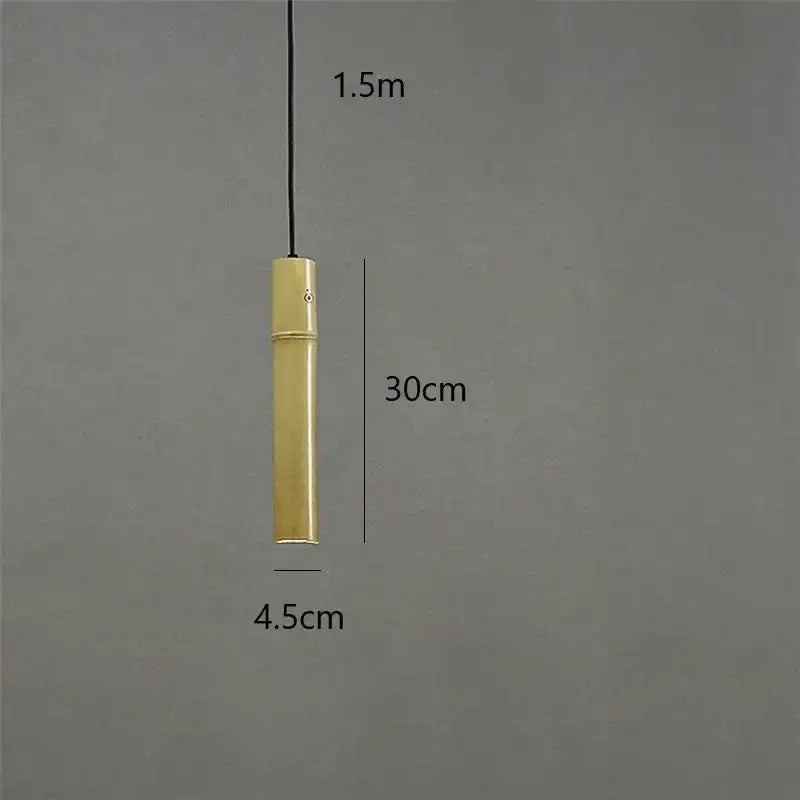 A sleek cylindrical brass tube pendant light with a minimalist design and 1.5 meter cord for dining room use