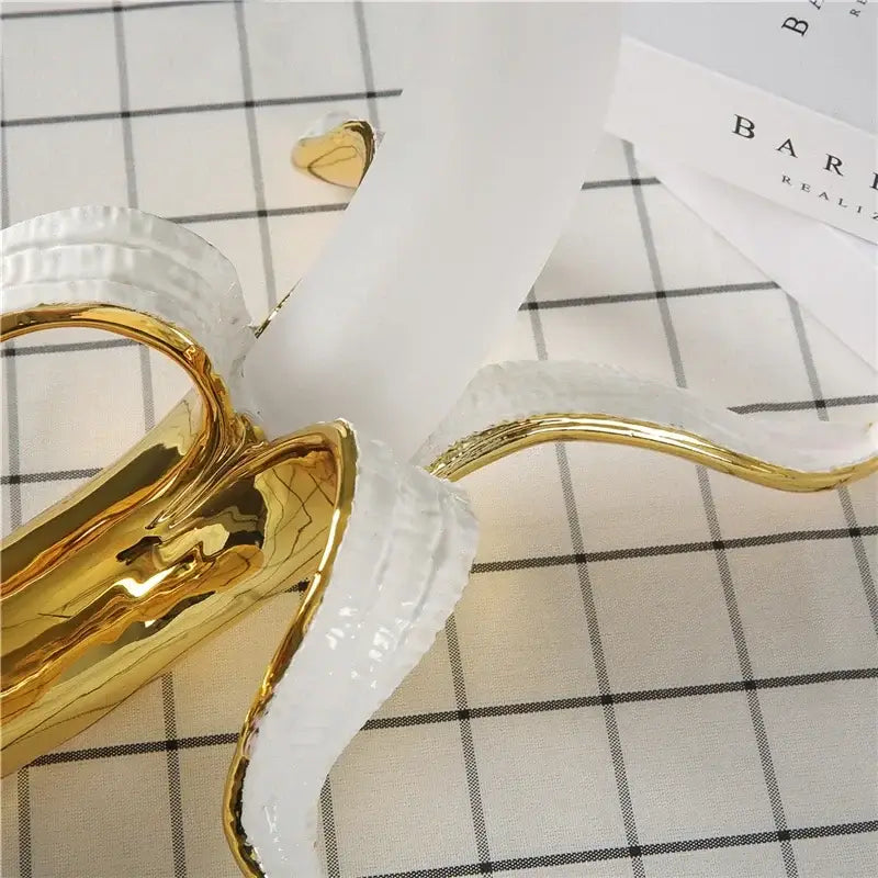Glossy gold and white ceramic banana sculpture with peeled design as a decorbites glass lampshade night light
