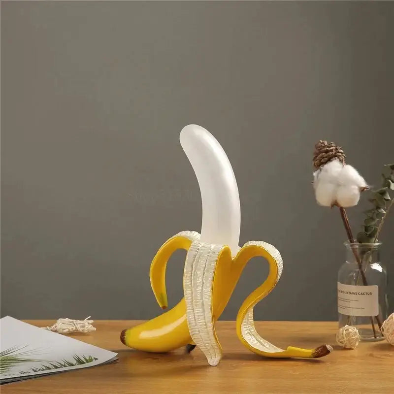 A glossy yellow banana-shaped decorbites glass lampshade night light with a peeled translucent white interior for bedroom decor