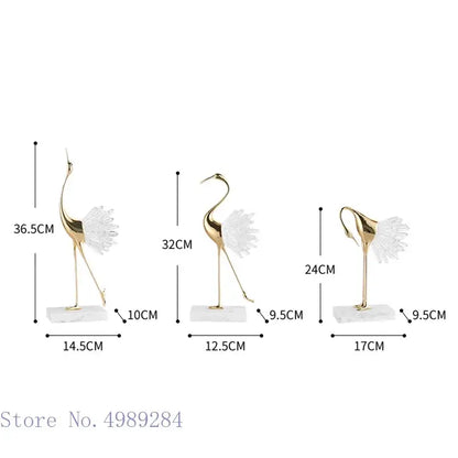 Three elegant gold-colored bird agate marble crane statues with translucent white wings on marble bases for home decor
