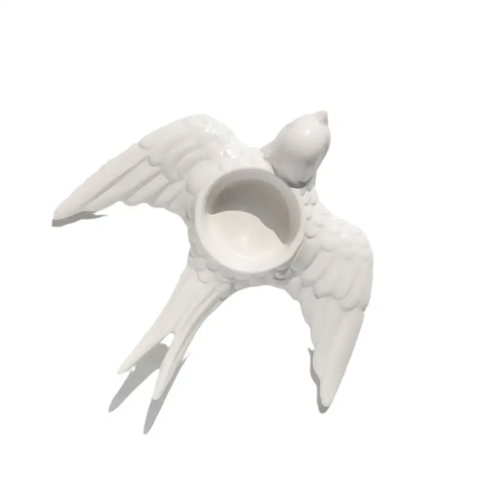White ceramic bird-shaped candle holder tray with detailed wings and tail feathers for wedding dining room decor