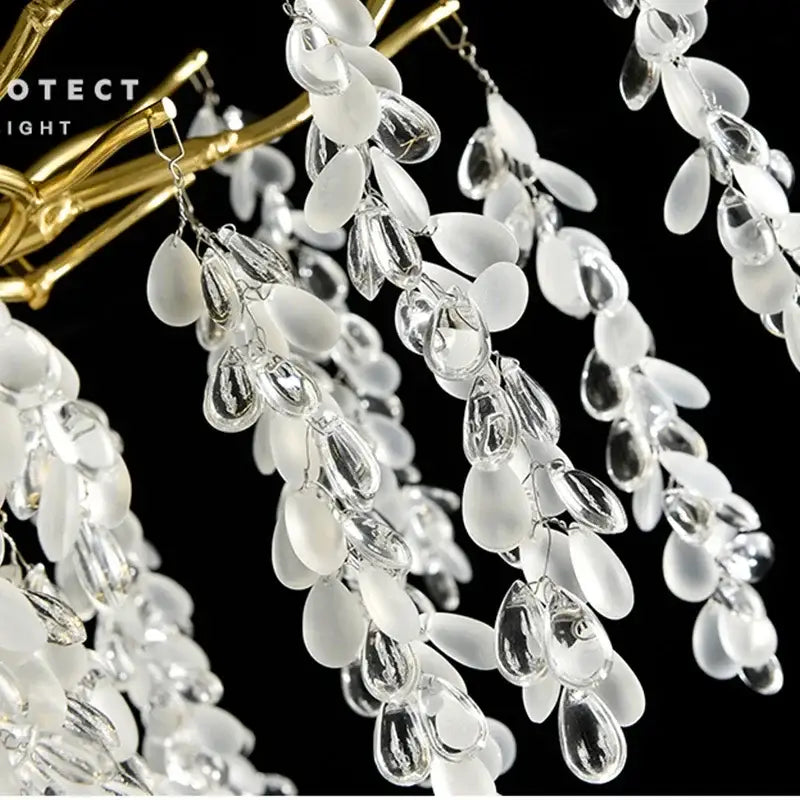 Elegant white and clear glass teardrop beads on a gold-toned frame in decorbites golden branch crystal chandelier