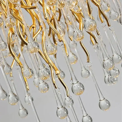 Elegant golden crystal chandelier with gold-toned metal and clear glass featuring teardrop crystal droplets for luxury lighting
