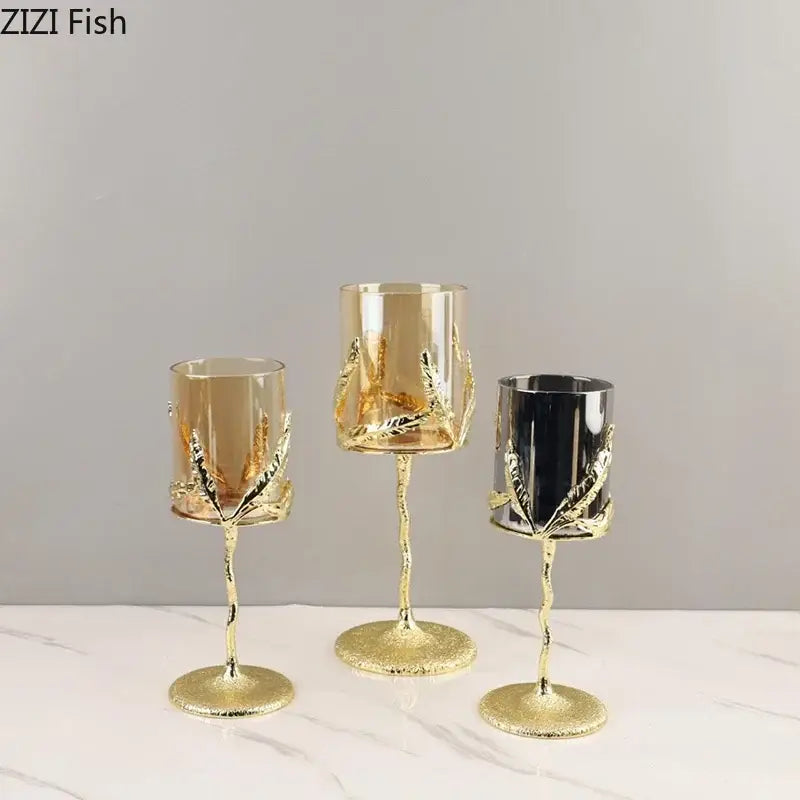 Three elegant gold-toned decorbites golden branches candle holders with gold leaf metal and amber black clear glass cups