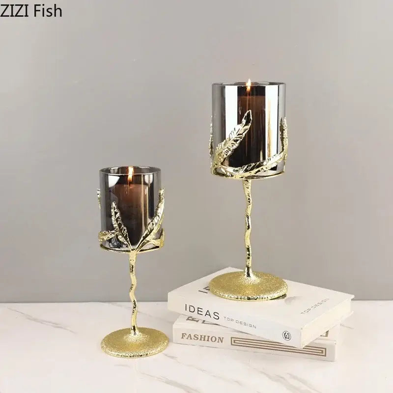 Elegant gold-toned decorbites golden branches candle holders with leaf detailing and dark glass cylinders for dining room decor