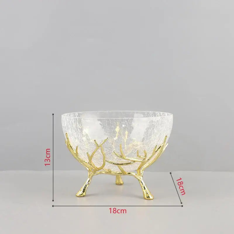 A clear crackled glass bowl with a golden branches antler-like metal stand in decorbites golden branches bowl set