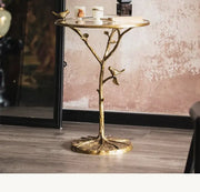 Golden brass bird tree side table with intricate branches and two small bird figurines for living room decorbites brass bird decor