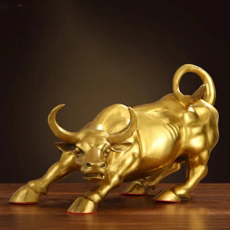 Golden brass bull figurine sculpture with detailed musculature and curved horns on wooden surface for office decorbites golden bull