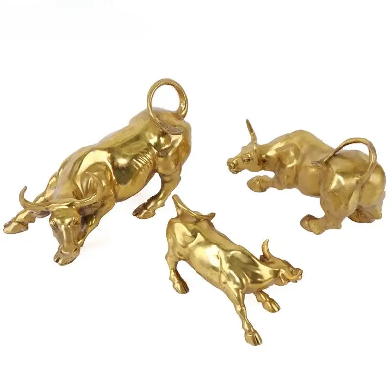 Three golden brass bull figurines with polished metallic finish and detailed musculature for office decorbites decor