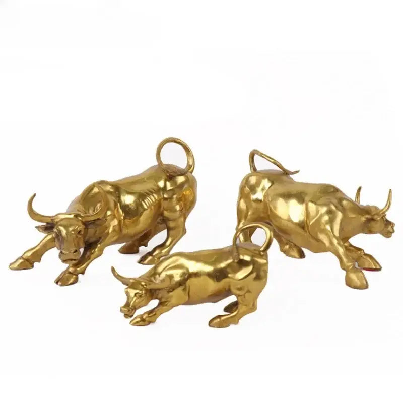 Three golden brass bull figurine sculptures with polished metallic finish and detailed musculature for office decorbites decor