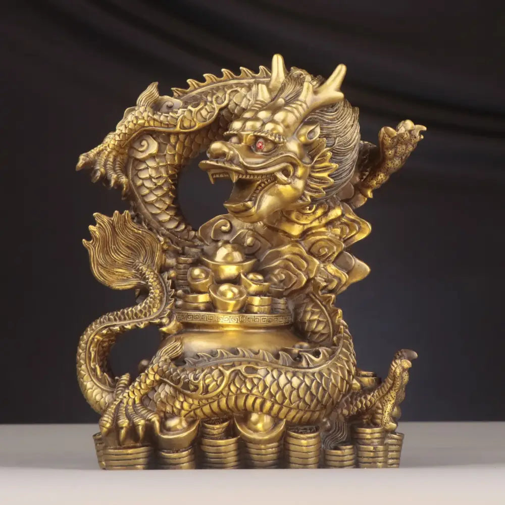 Golden brass dragon copper bowl ornament with intricate scales and red eye coiled on stacked coin pedestal for decor